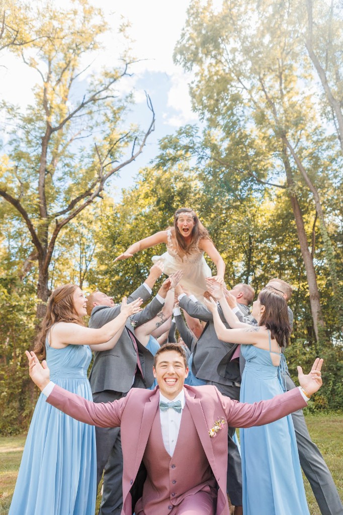 Your Name and the wedding party tossing the bride in the air